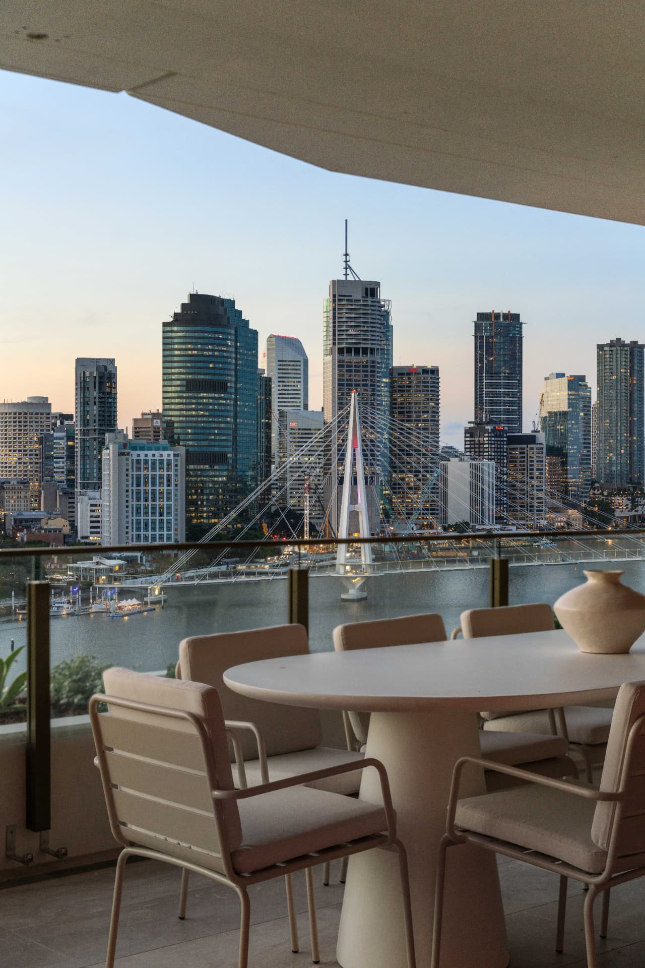 Balcony view across the Brisbane River and the Kangaroo Point bridge at dusk